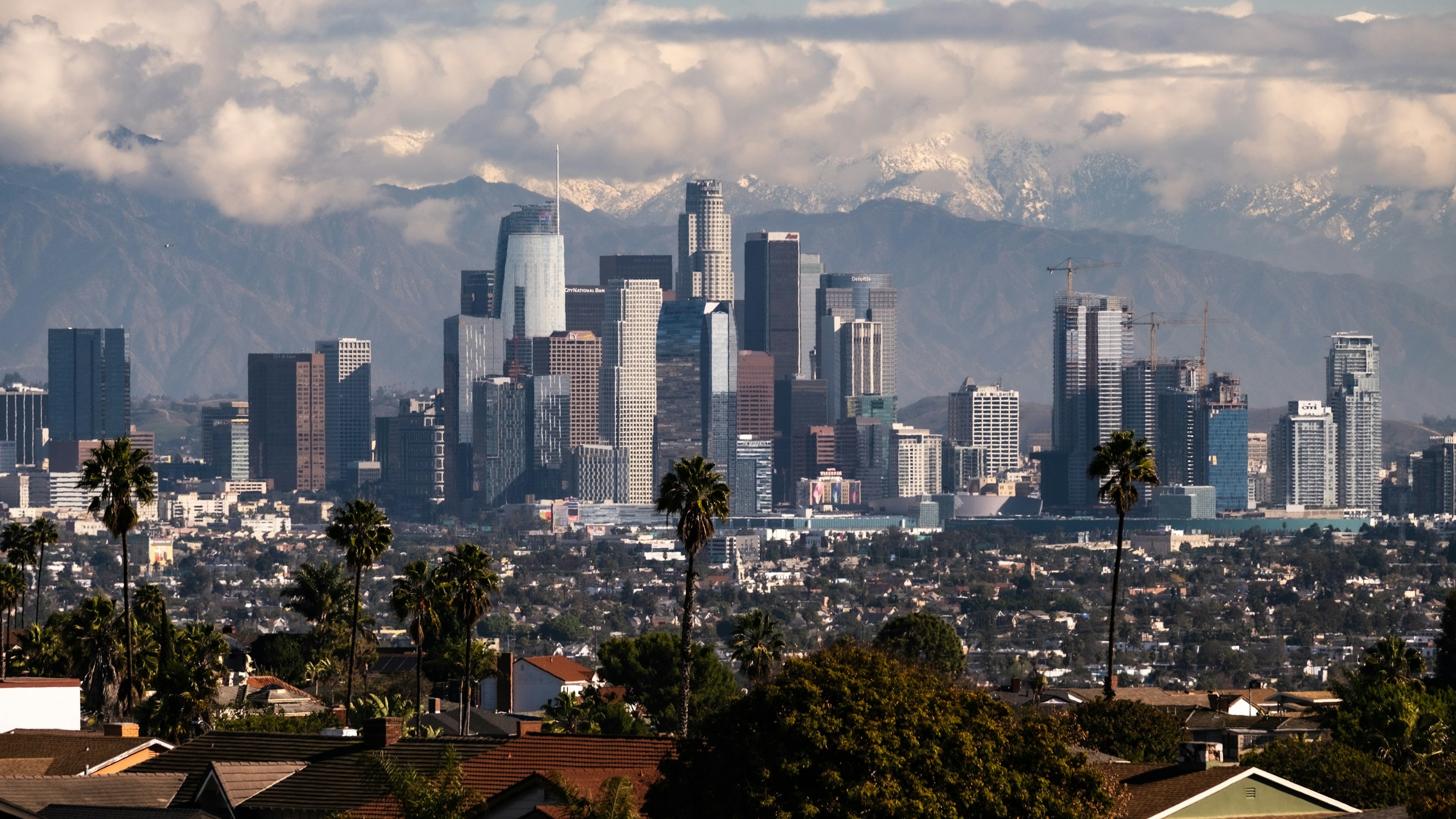 The downtown Los Angeles skyline with the snow-capped San Gabriel Mountains behind it